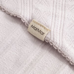 Light pink scarf with fringe edge and woven pattern, detail with brand.