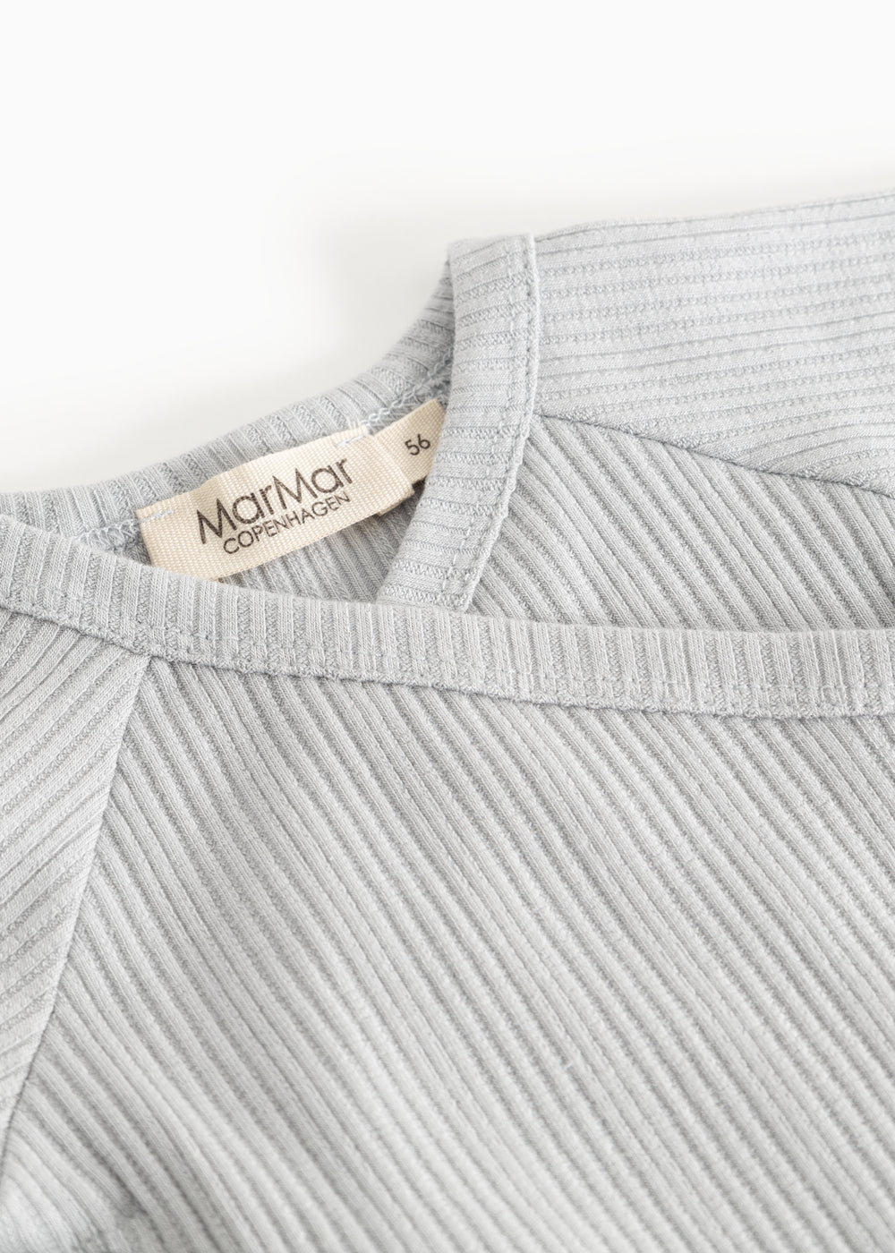 Light gray ribbed knit blouse with a V‑neck and a label at the back.