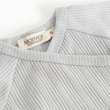 Light gray ribbed knit blouse with a V‑neck and a label at the back.