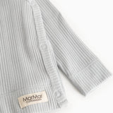 Light gray ribbed blouse with long sleeves and a snap button at the opening.