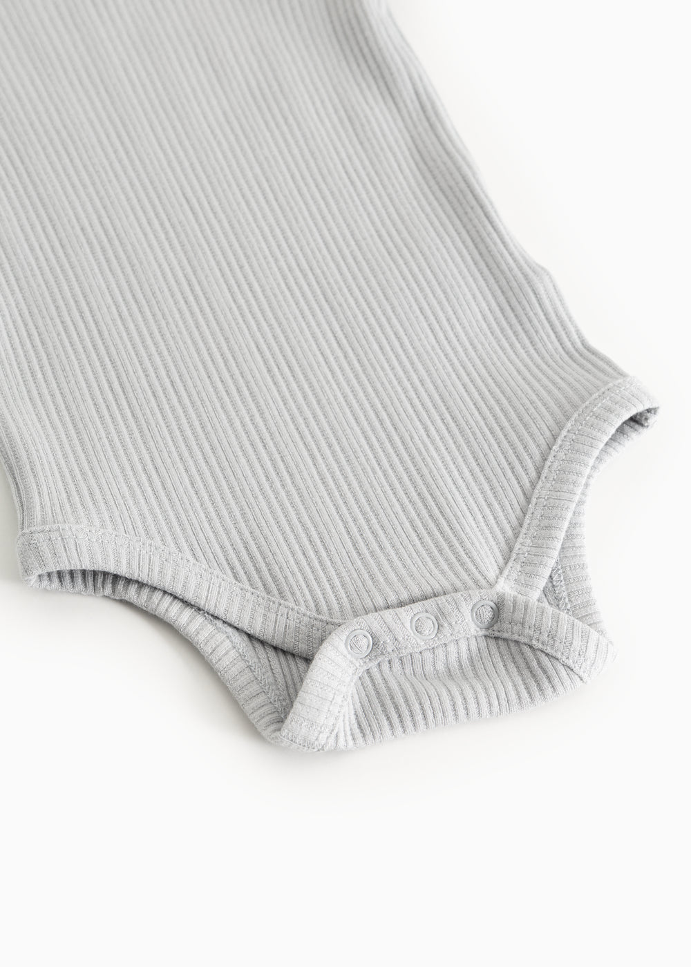 Sheer bodystocking in light gray-blue rib knit with elastic leg openings.