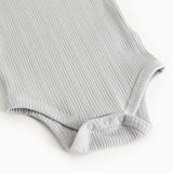 Sheer bodystocking in light gray-blue rib knit with elastic leg openings.