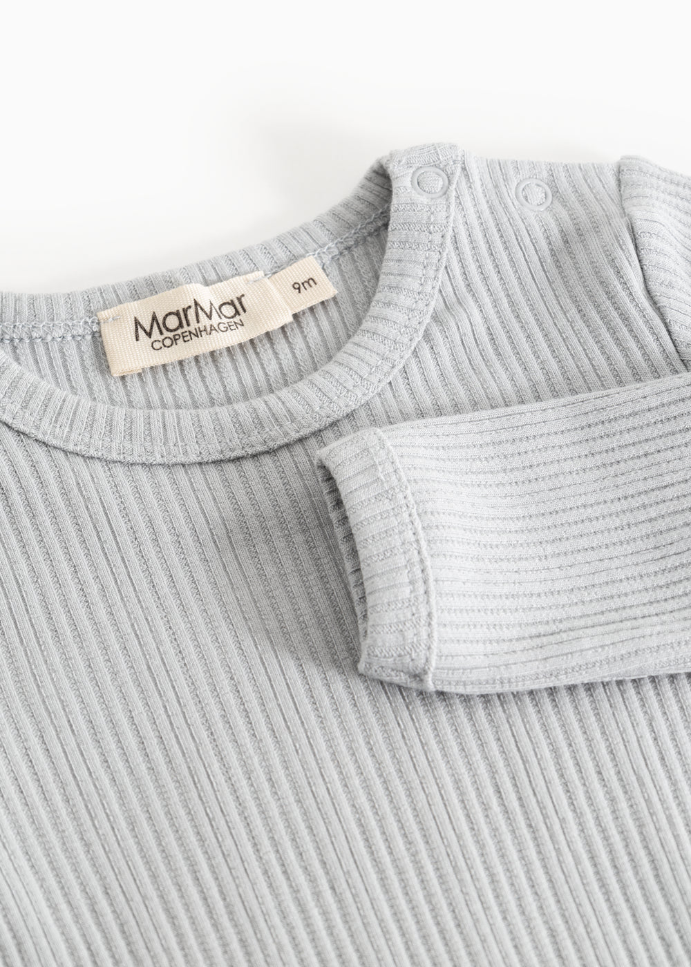 Sheer bodystocking in light gray-blue ribbing with a snap button closure at the neckline.