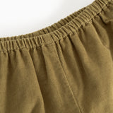 Dark bronze baby pants with elastic waist and pleated lining.