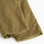 Dark bronze baby pants with ribbed edge at the bottom and visible seam.
