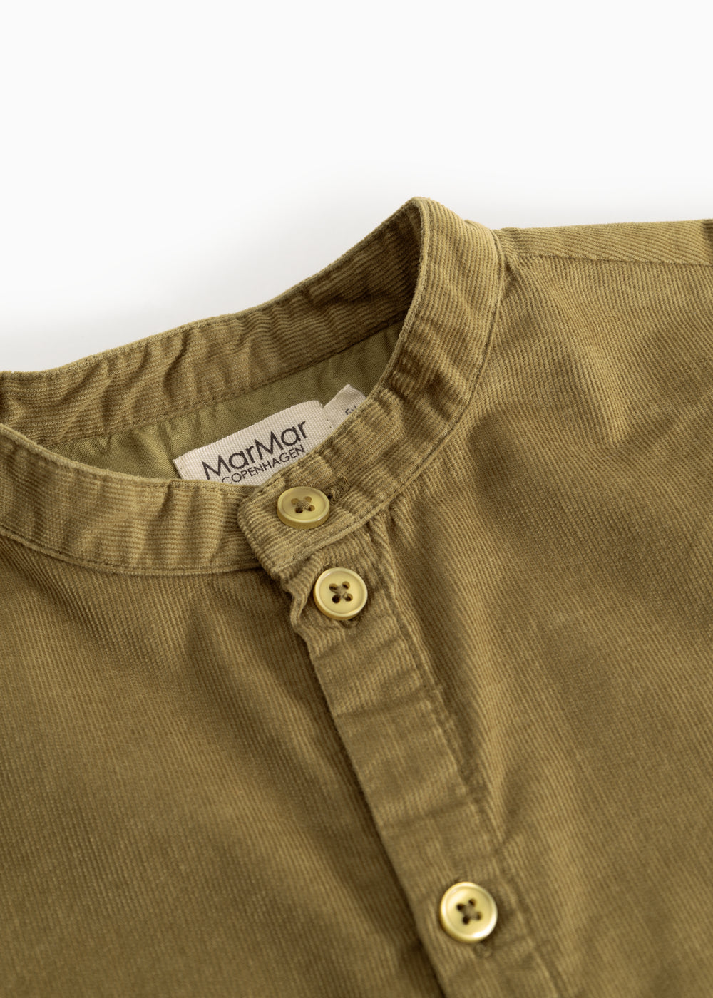 Kids shirt in dark bronze with button closure at the neckline and visible buttons.