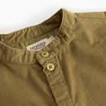 Kids shirt in dark bronze with button closure at the neckline and visible buttons.