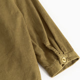 Kids shirt in dark bronze, long-sleeved with button cuffs and visible buttons.