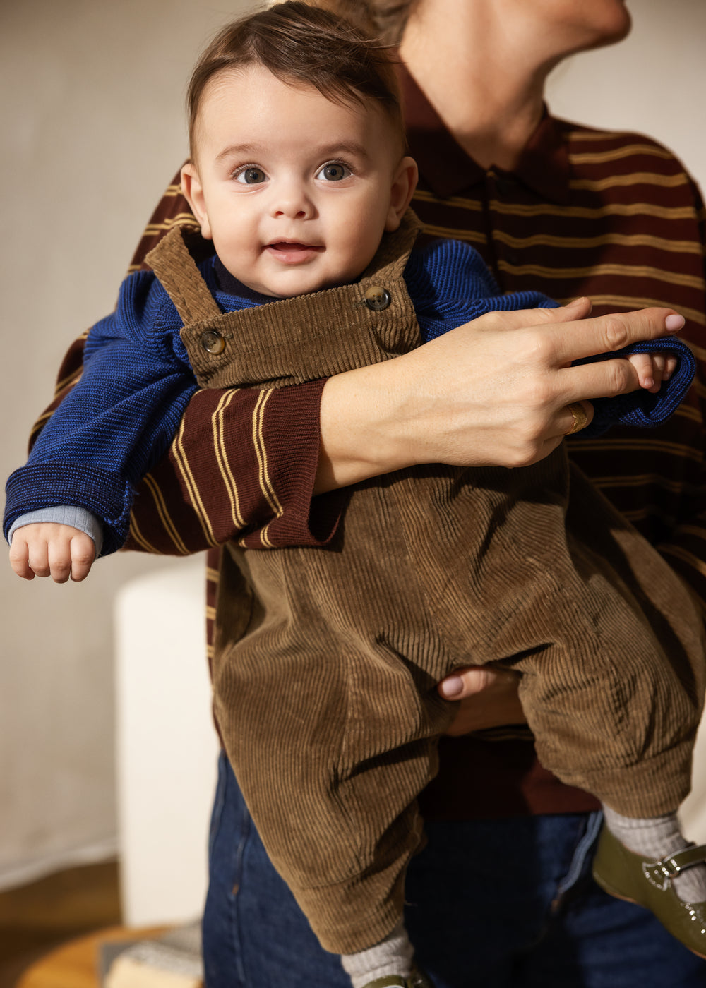 Striped polo shirt in dark shades for children with a button-down collar and long sleeves