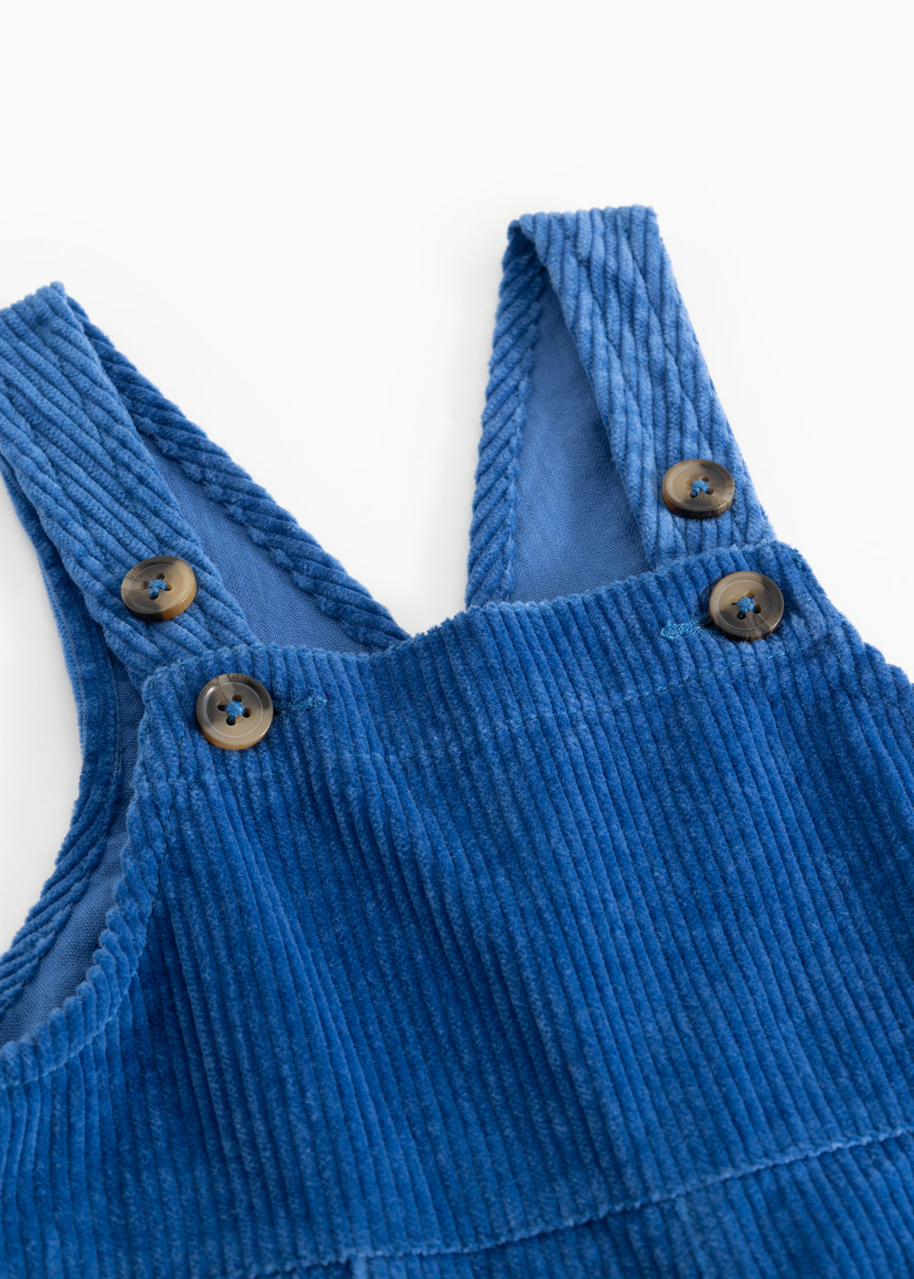 Blue suspenders with round buttons on the chest and adjustable straps.