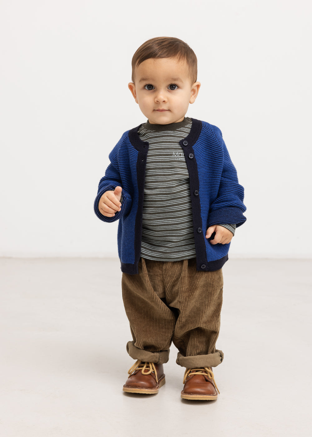 Baby onesies in dark brown velvet with elastic waist and loose legs for a toddler.