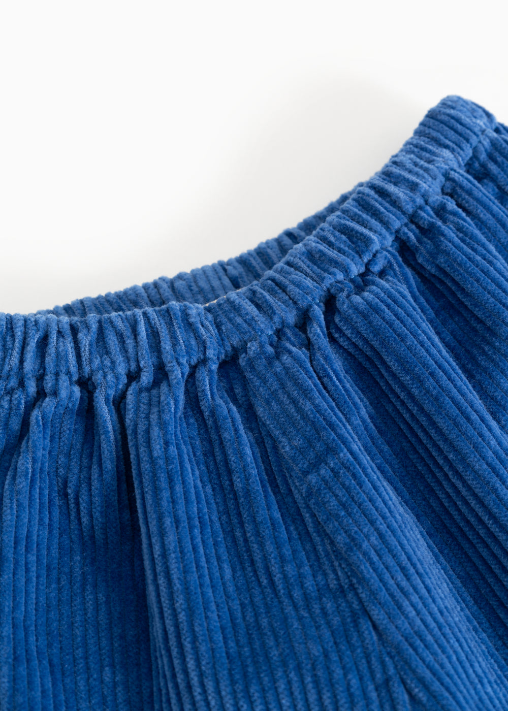 Dark blue baby pants with a creased elastic waistband.