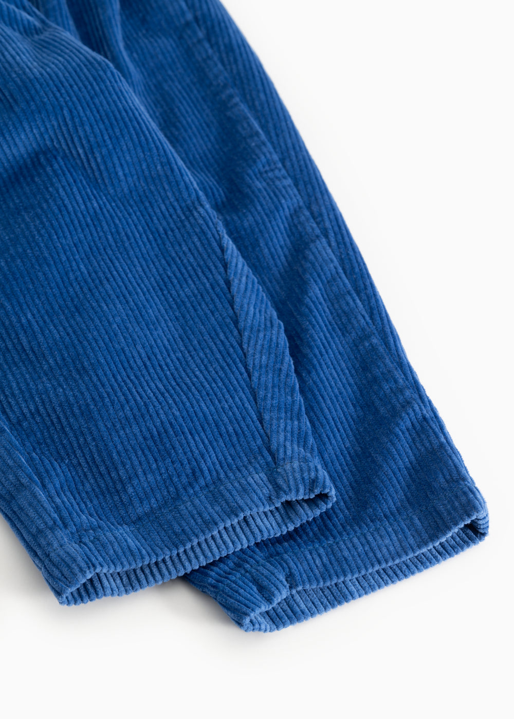 Dark blue baby pants with visible seam and ribbed edge at the bottom.