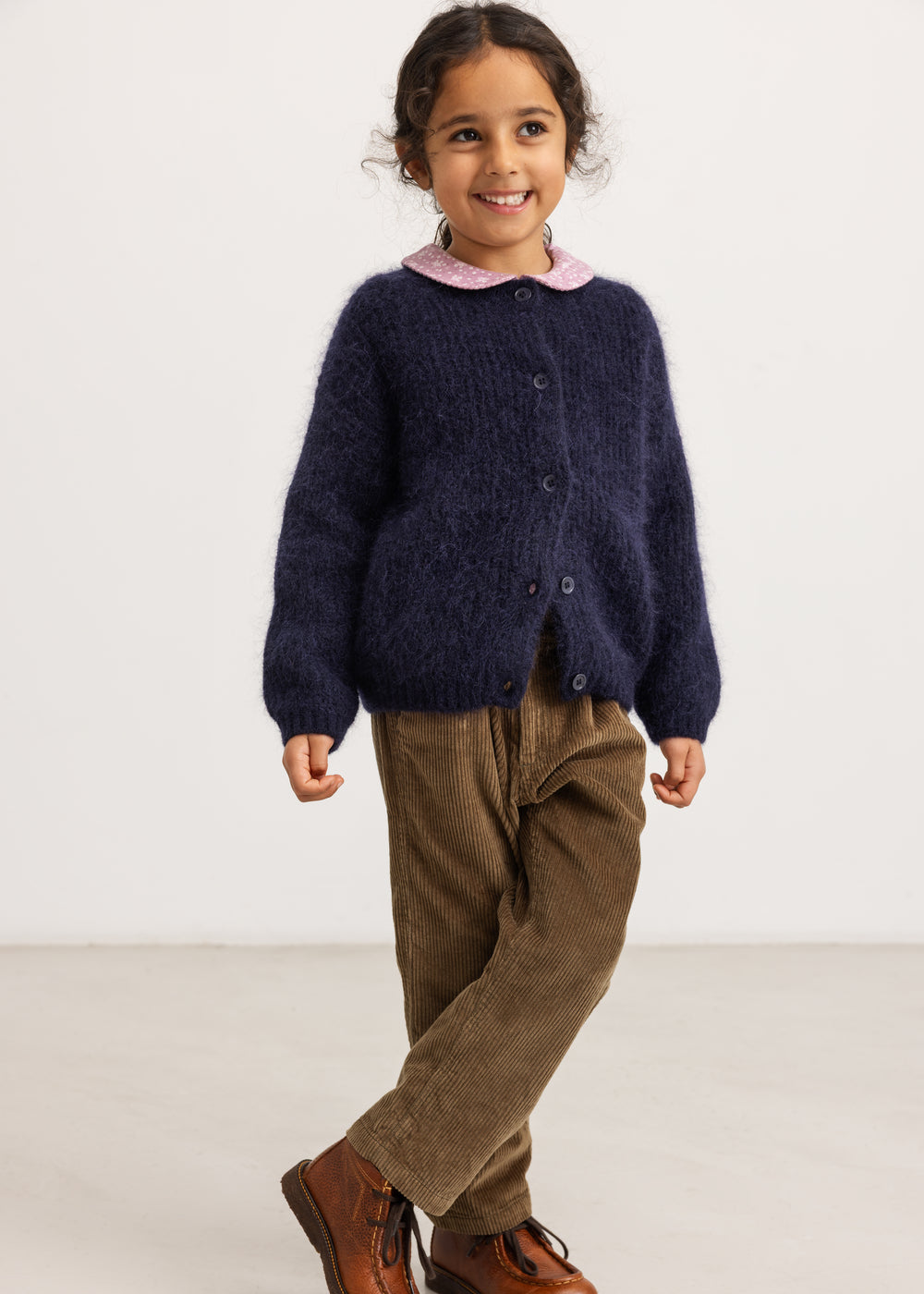 Dark brown corduroy pants with elastic waistband and side pockets, wide legs.