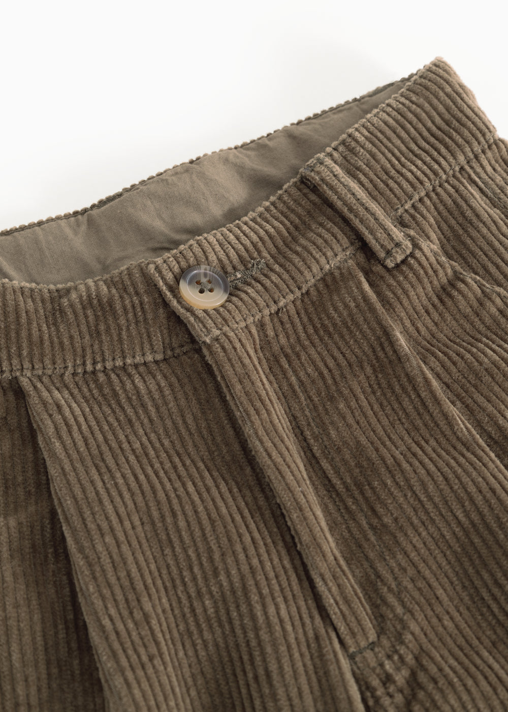 Brown corduroy pants: ribbed waistband with button closure and visible seams.