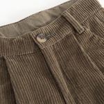 Brown corduroy pants: ribbed waistband with button closure and visible seams.