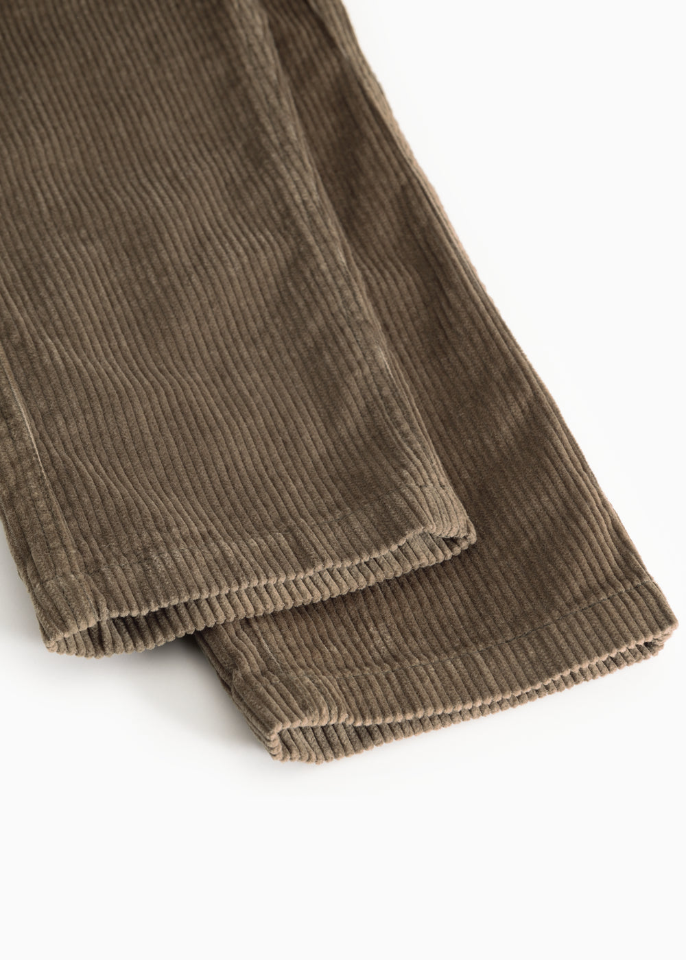 Brown corduroy pants with ribbed edge at the leg ending and seam.