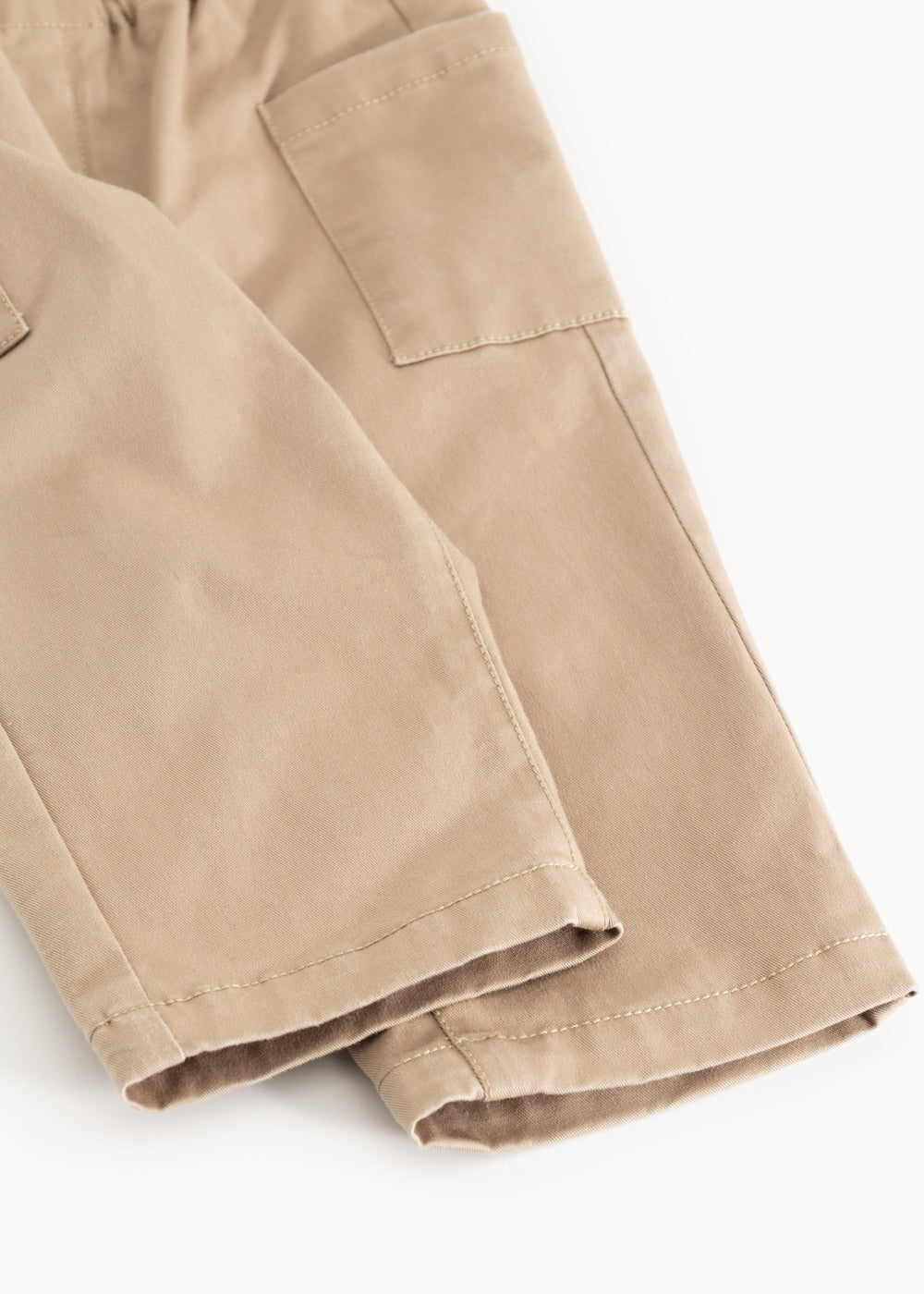 Leather trousers in dark beige with cuffs at the bottom and seam details.