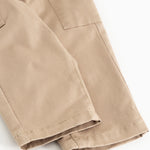 Leather trousers in dark beige with cuffs at the bottom and seam details.