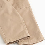 Leather trousers in dark beige with cuffs at the bottom and seam details.