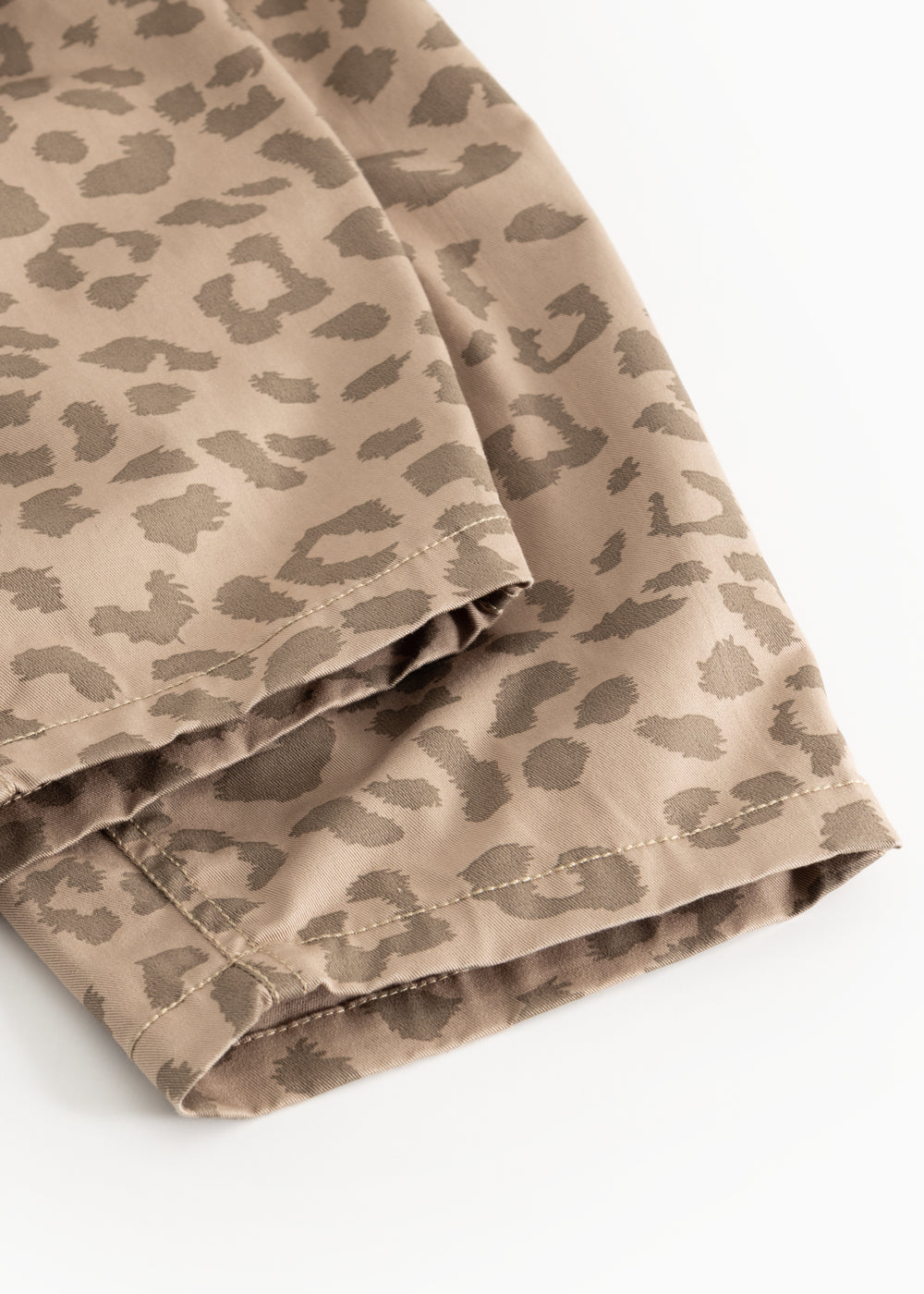 Pants with a warm leo print in light brown, visible seam and hem.