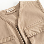 Beige children's vest with V-neck, zipper and flap pockets, and inner label.