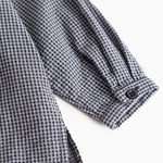 Striped shirt sleeve with cuff and buttons, dark navy blue checkered.