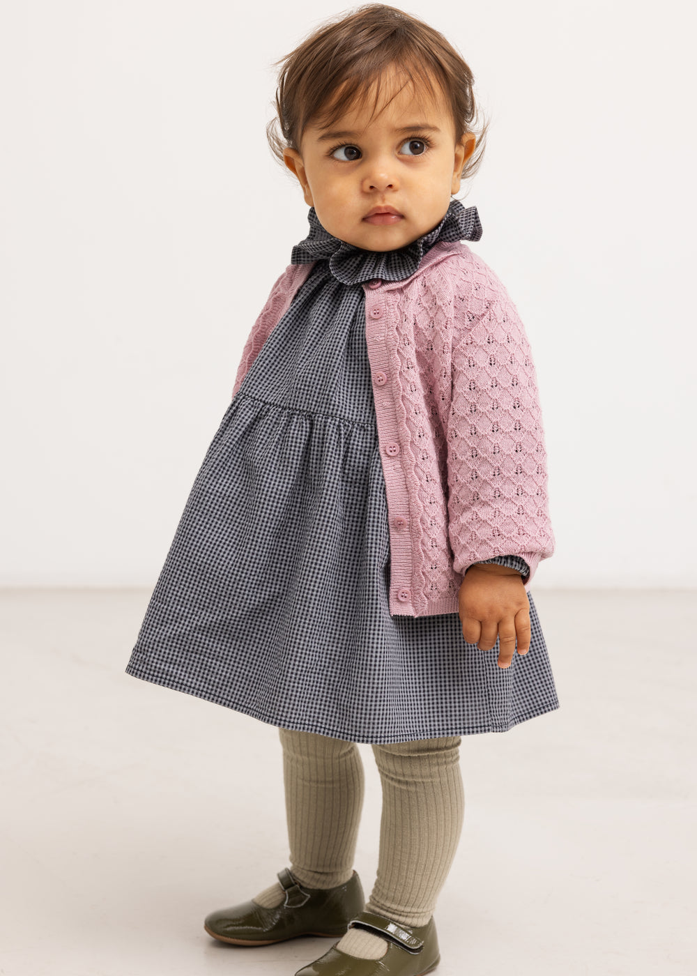 Pink knit cardigan with buttons, worn by baby