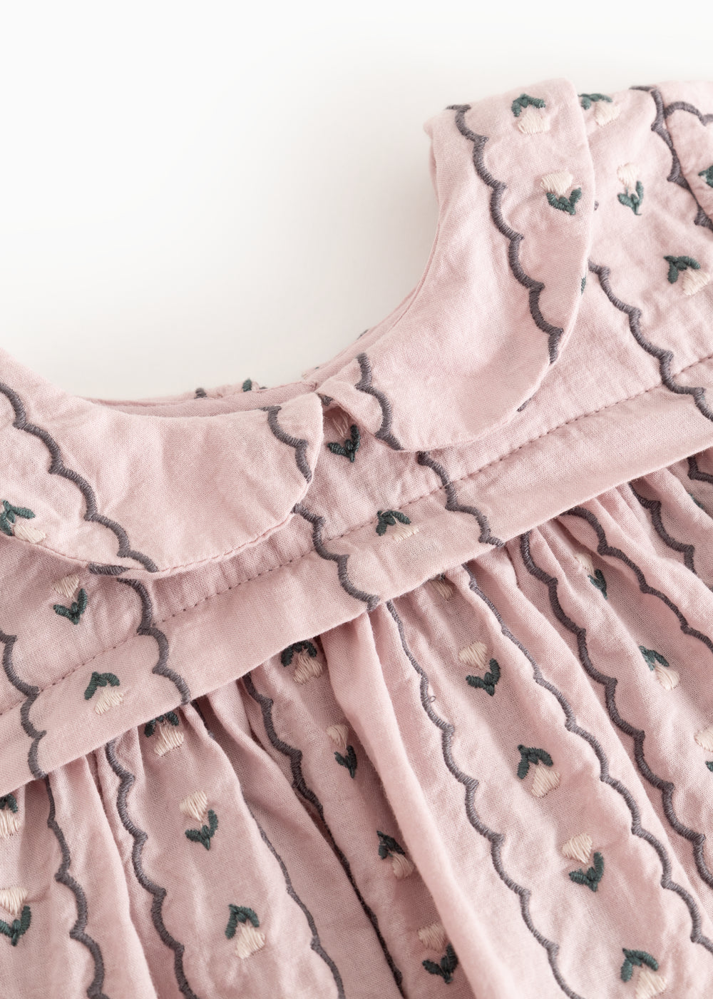 Pink blouse with high collar, front buttons and scalloped edge with embroidery