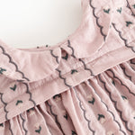Pink blouse with high collar, front buttons and scalloped edge with embroidery