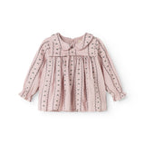 Pink baby blouse with button closure, ruffled details, and long sleeves.