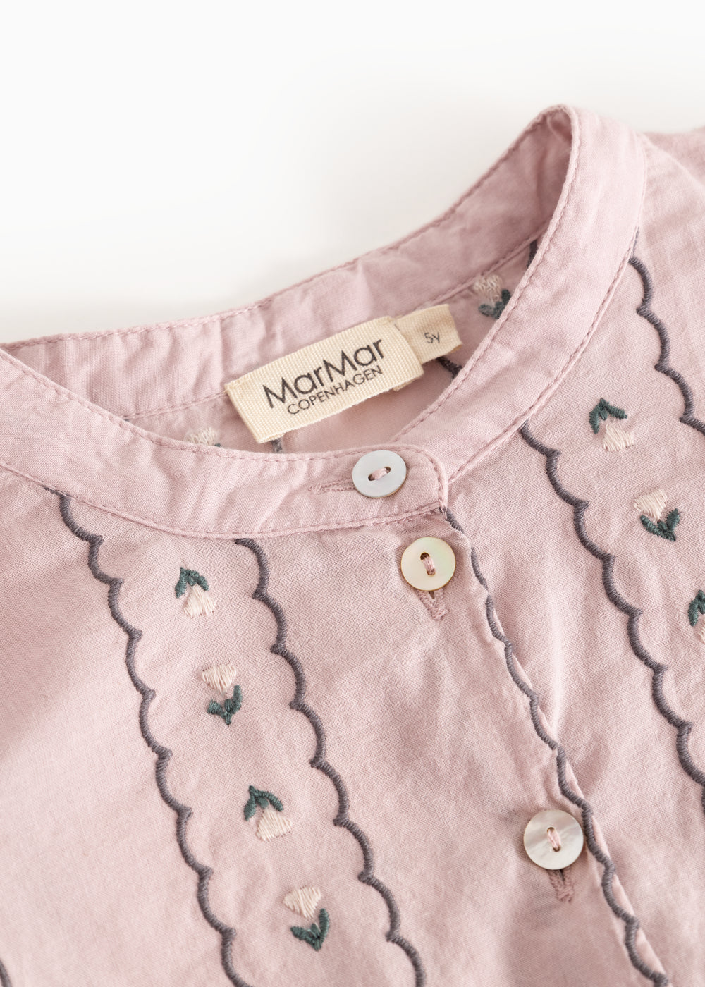 Dress the dust purple with front button closure and floral embroidery.