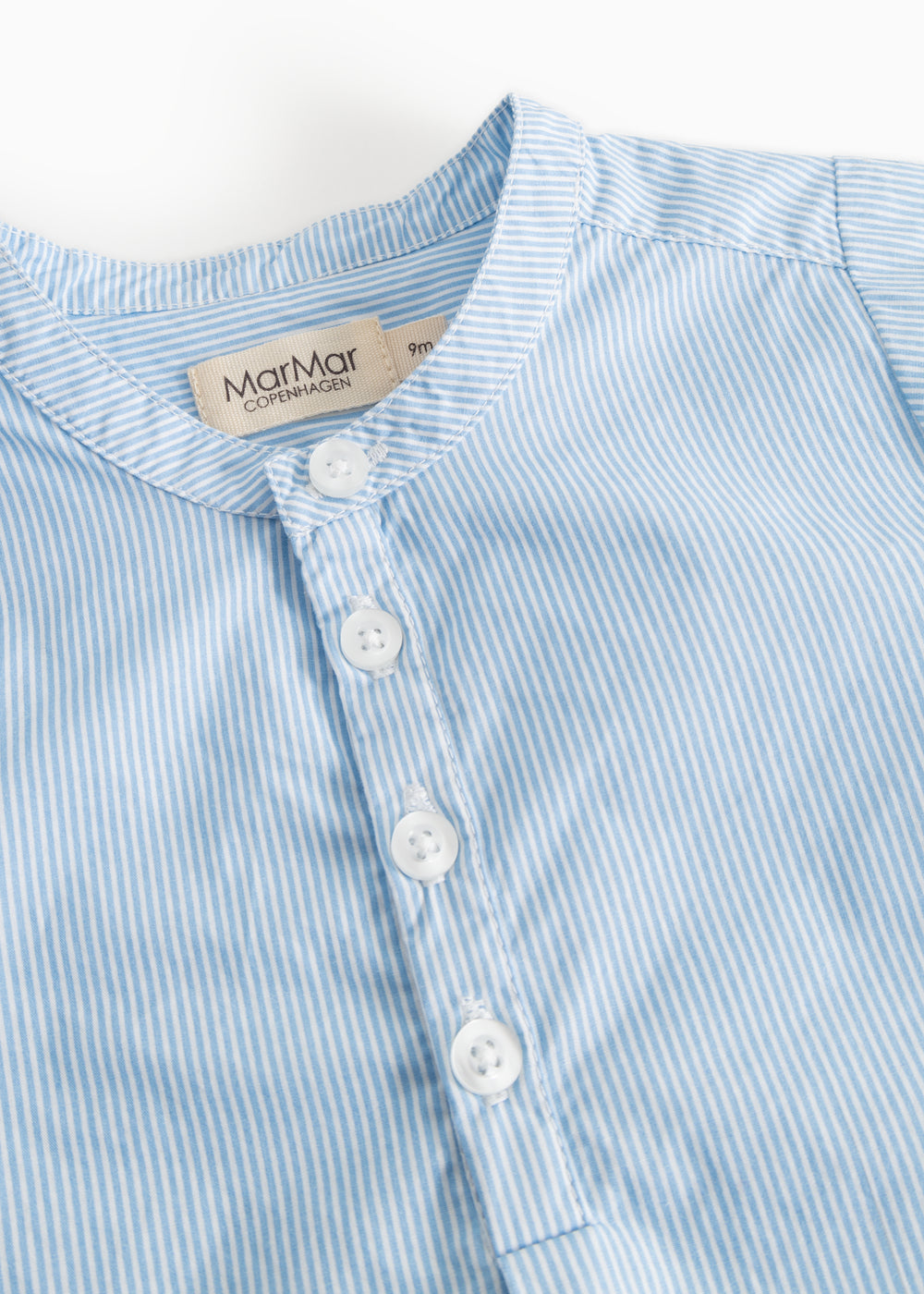Light blue striped shirt with button closure in front and a collar.