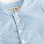 Light blue striped shirt with button closure in front and a collar.