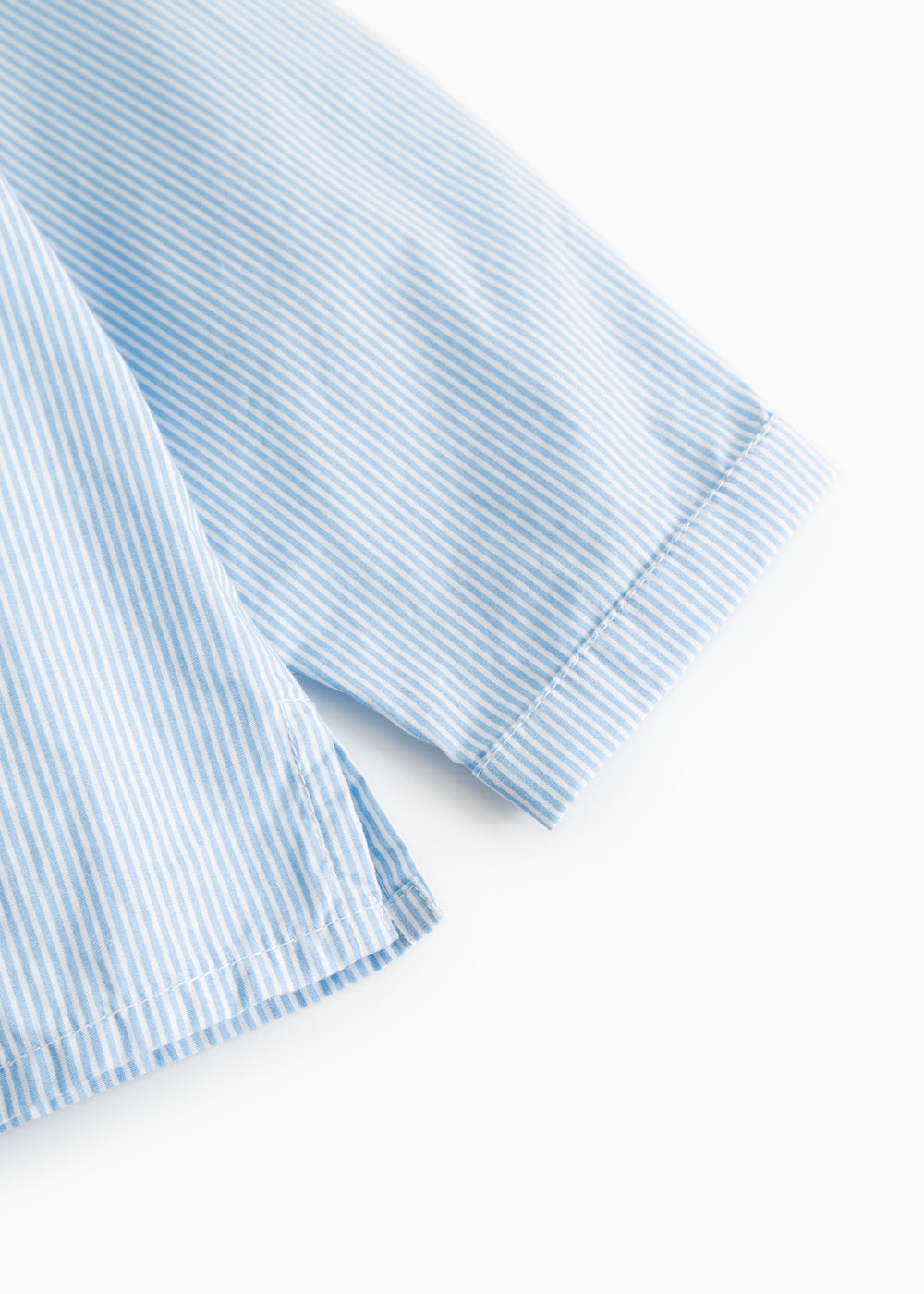 Light blue striped shirt with short sleeves and cuff trim.