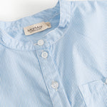 Light blue striped shirt with round neckline and three buttons.