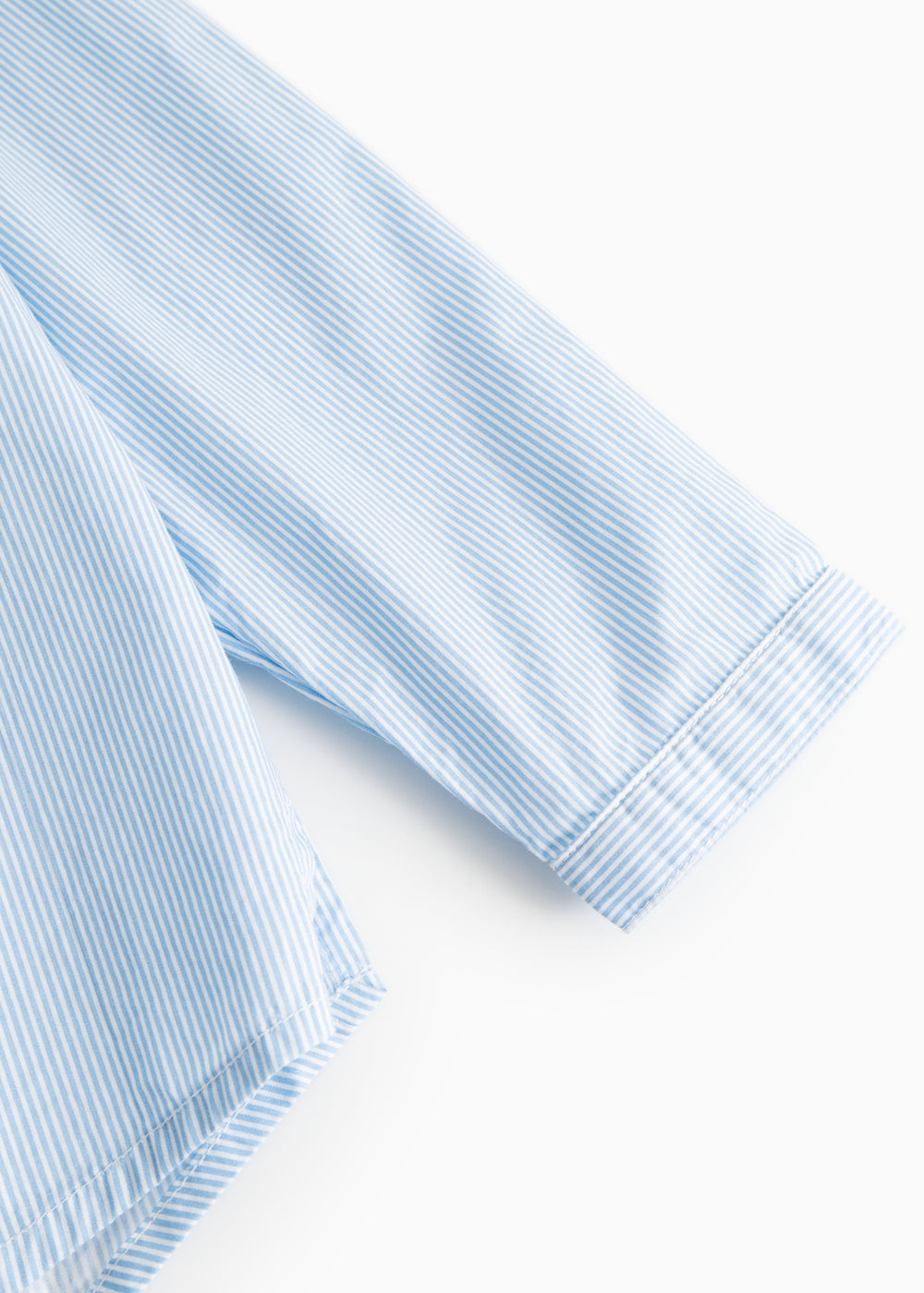 Striped shirt sleeves in light blue and white with button cuffs.