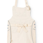 Natural-colored apron with cat print, waist tie, and shoulder straps.