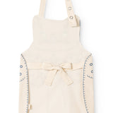 Natural-colored apron with cat print, waist tie, and shoulder straps.