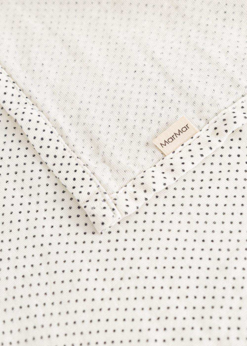 Stainless steel with small black dots and white edge, MarMar logo on the fold.