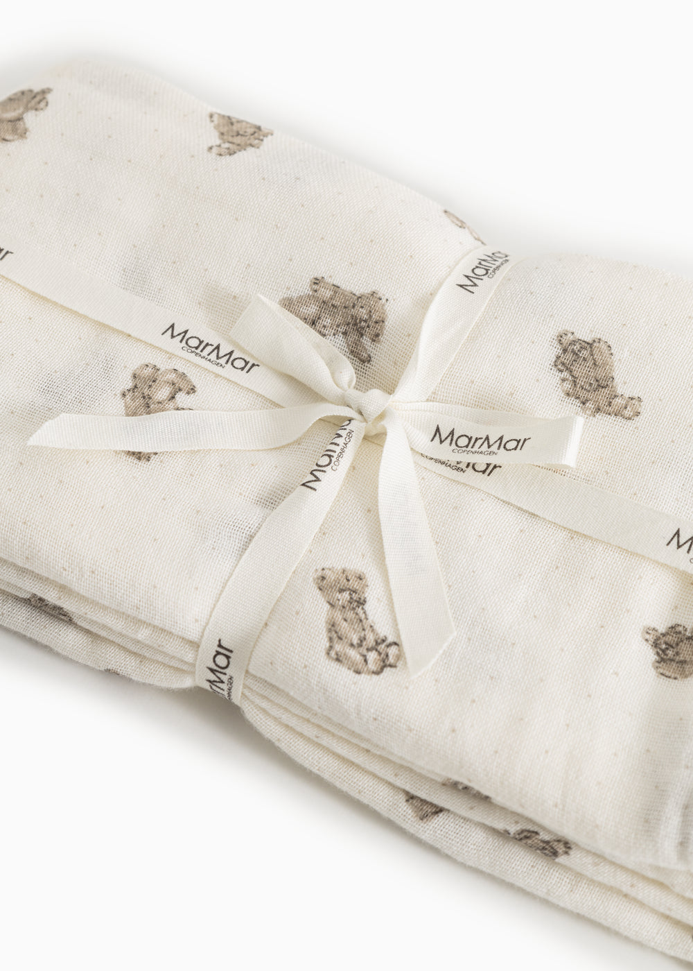 Baby wrap in cream folded with visible marble labels.