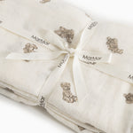 Baby wrap in cream folded with visible marble labels.