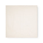 Baby ones laid flat in cream color with a subtle pink flower/ polka dot pattern.