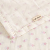 Cream-colored baby onesie with small pink flowers, ruffle edge, and MarMar brand.