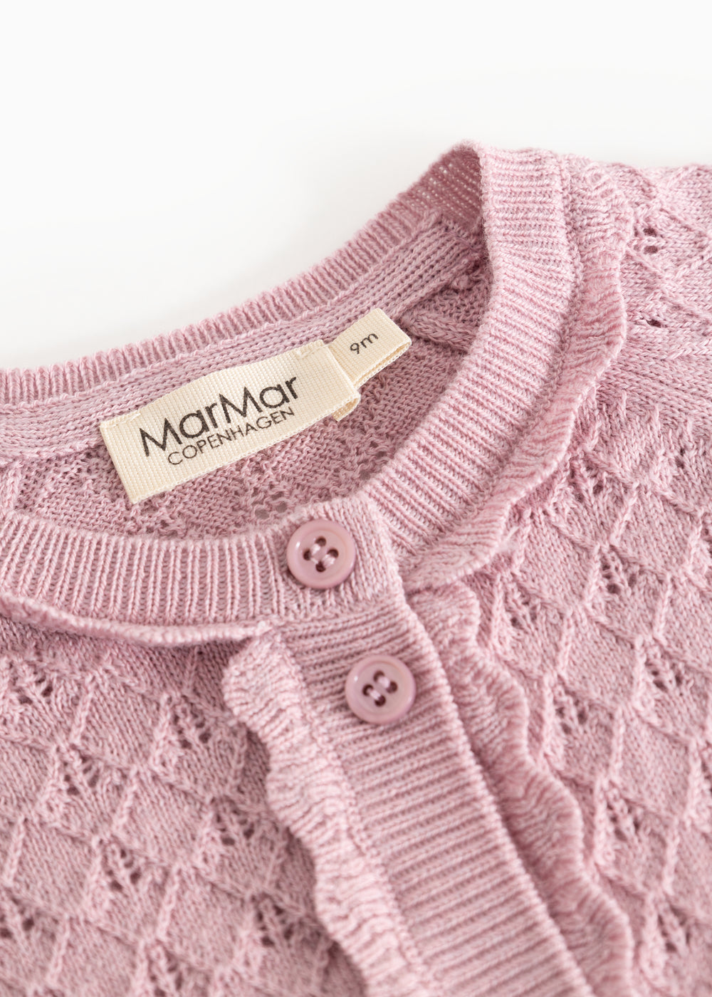 Pink knit cardigan with ribbed edge, buttons and MarrMar Copenhagen label at the neckline.