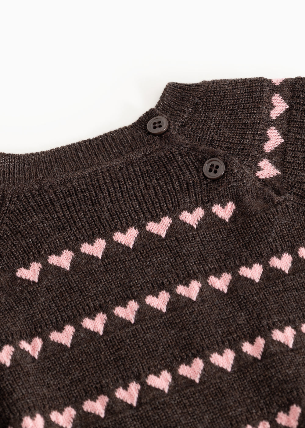Sort striped blouse with pink hearts and buttons at the neckline.