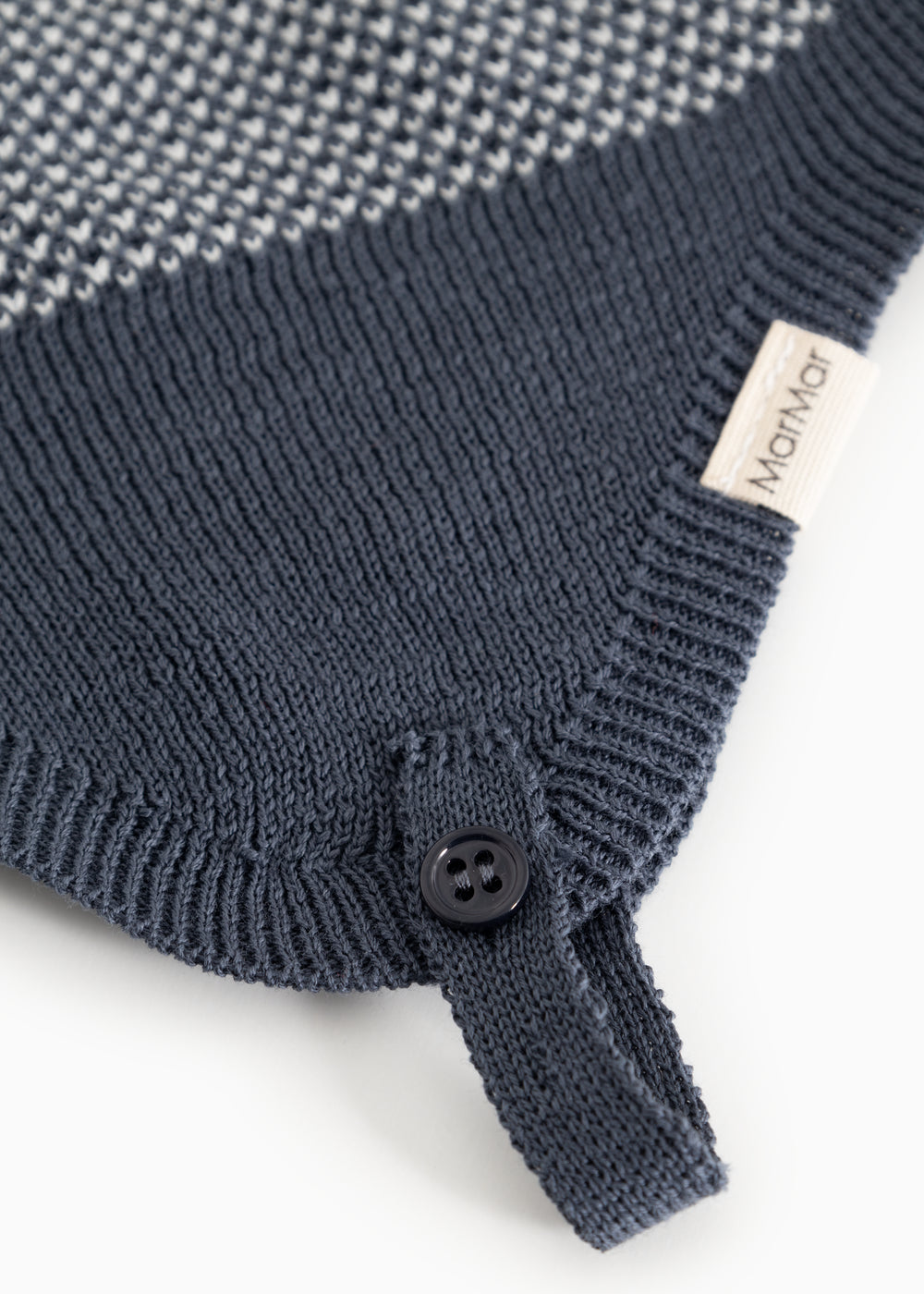 Blue striped hood with button closure and ribbed edge; white label at the drawstring.