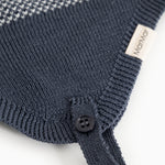 Blue striped hood with button closure and ribbed edge; white label at the drawstring.