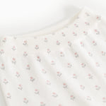Elastic-waisted trousers with elastic ribbing at the waist and repeated floral pattern.