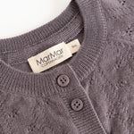 Dark purple knitted cardigan with ribbed edge, two buttons and a label.
